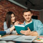 university-students-reading-textbook-together.jpg